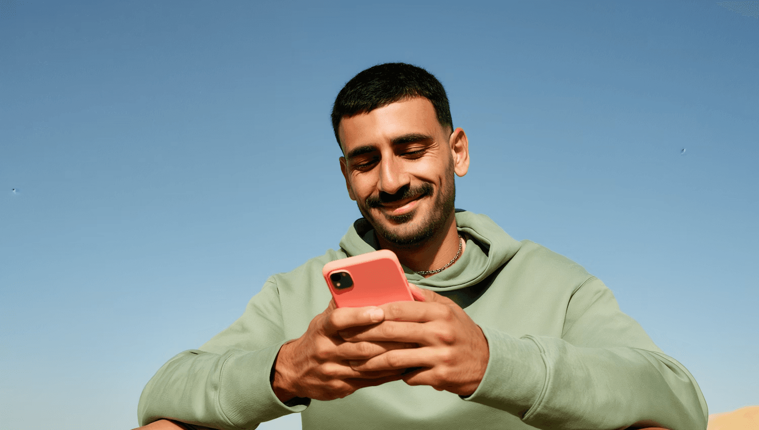 Man holding phone showing Niftipay app
